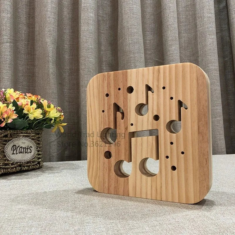 Square 3D wooden lattice USB lamp emitting warm white light on a desk, showing pine grain and USB cable.