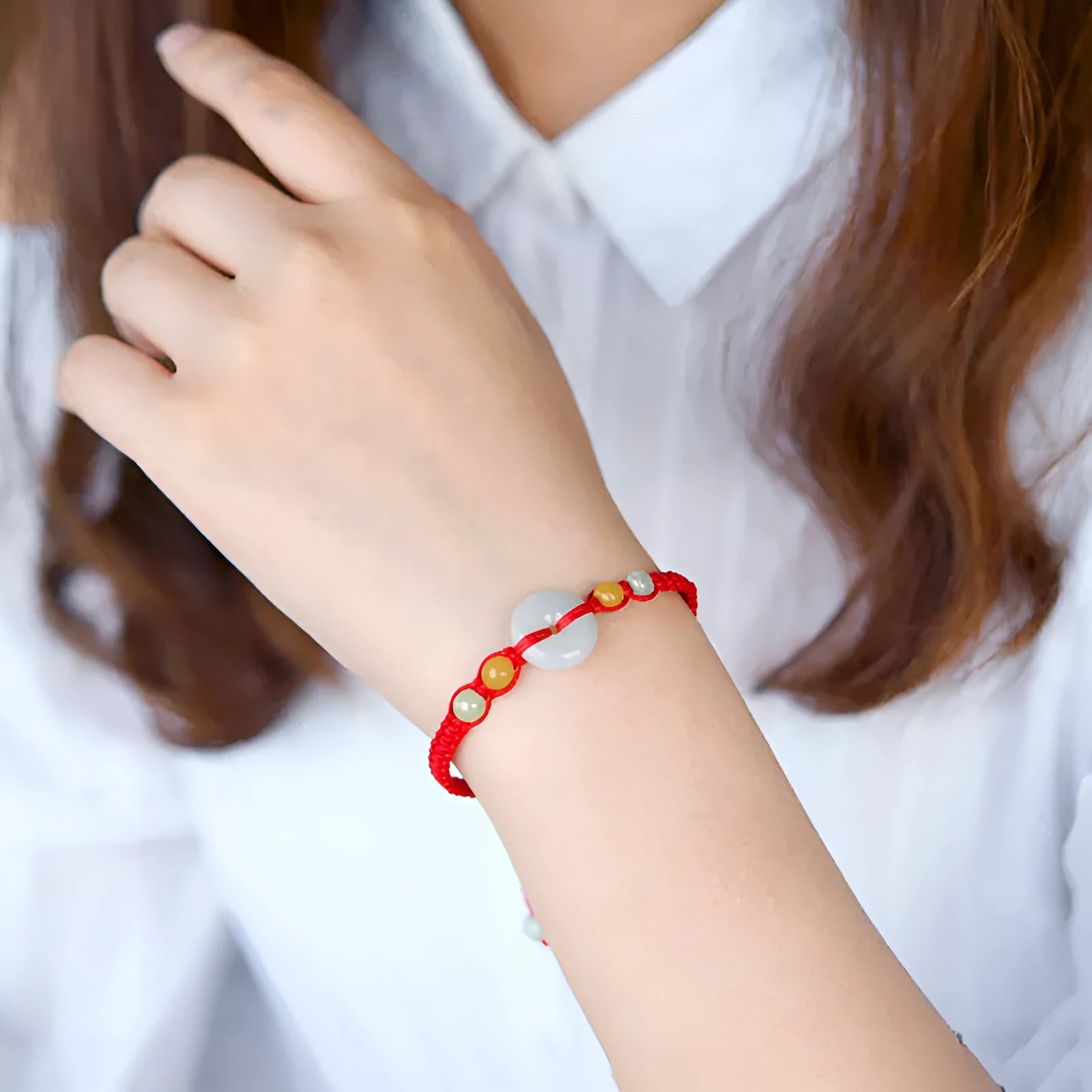 Burmese jade round pendant on an adjustable red rope bracelet with certificate.