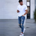 Deep blue men's jeans with distressed hole design showing cotton fabric texture