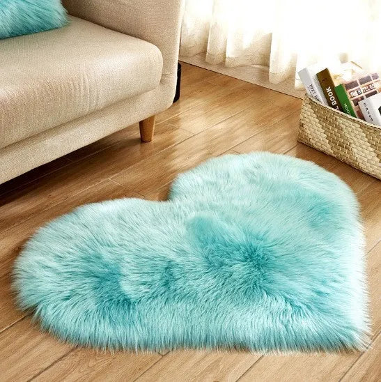 Heart-shaped plush carpet in multiple colours showing wool-like texture with 5-6 cm pile length