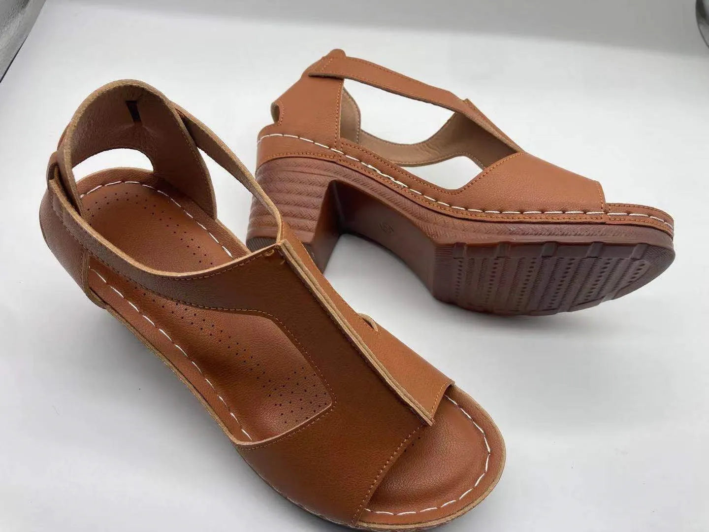 Women's peep toe wedge sandal with buckle on low heel, open fish mouth toe, in light brown