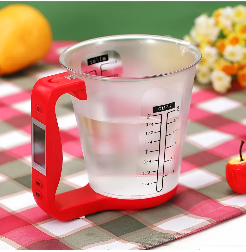 Green digital kitchen scale measuring cup with LCD display in handle on kitchen counter