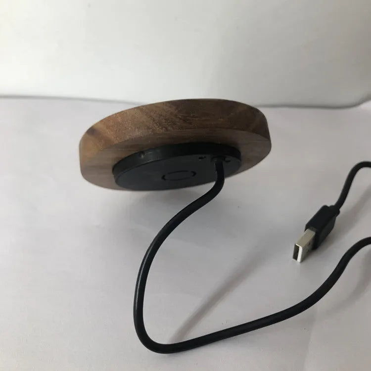 Black 60mm round wireless phone charging pad for furniture installation