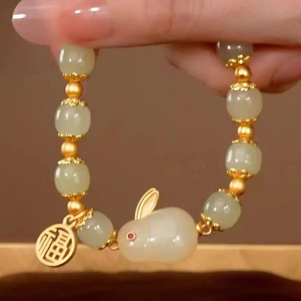 Green lucky bracelet with fu character charm, jade hare charm, and black bracelet base