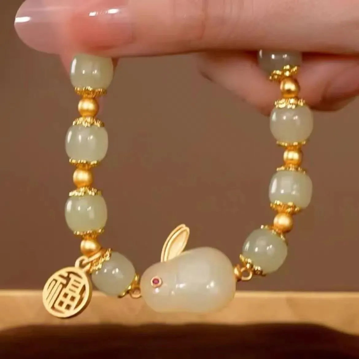Green lucky bracelet with fu character charm, jade hare charm, and black bracelet base