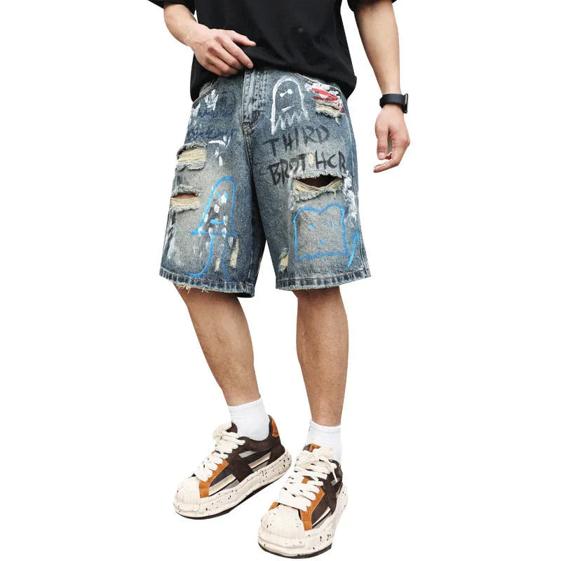 Men's blue ripped jeans shorts with straight leg cut, zipper fly, and graffiti detailing