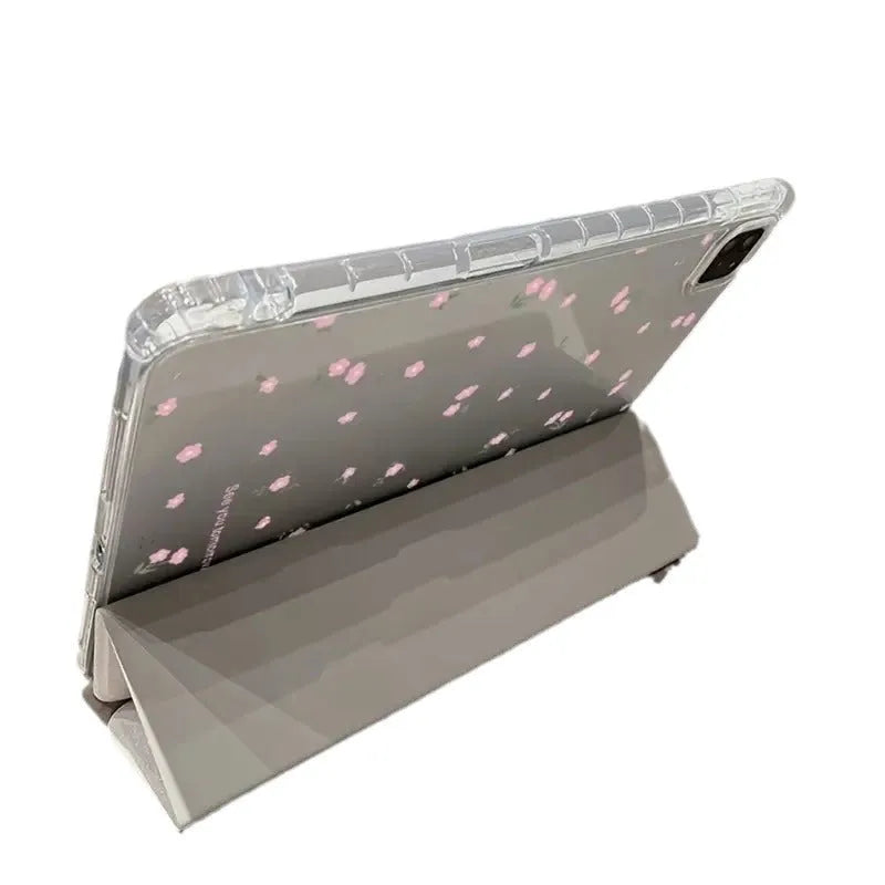 Transparent tri-fold Apple iPad case with cartoon floral print showing magnetic stand function.