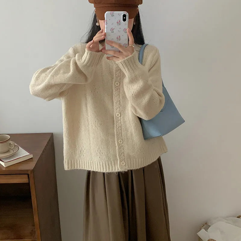 Retro style loose-fit viscose fibre cardigan in apricot colour, shown on a hanger.
