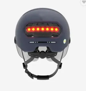 Cycling helmet with integrated red LED brake light on the rear, shown in two style variations.