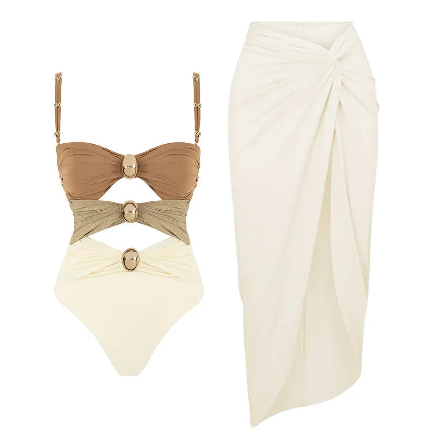 Women's solid colour one-piece swimsuit with gold button and matching skirt in assorted colours.