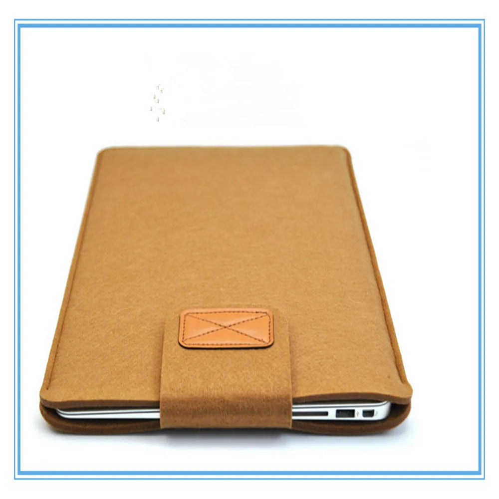 Dark grey plush felt vertical clutch laptop bag showing clamshell opening and structured interior.