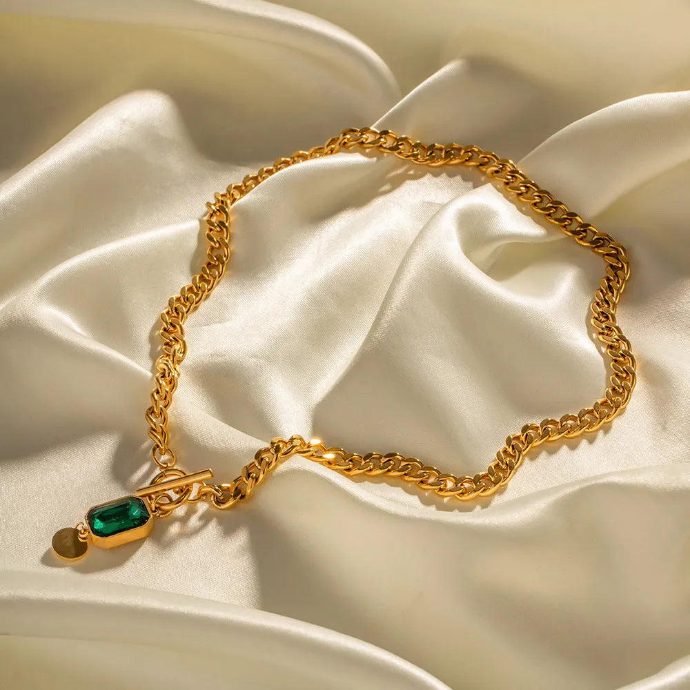 Gold electroplated titanium steel necklace with geometric pendant and emerald zircon stone