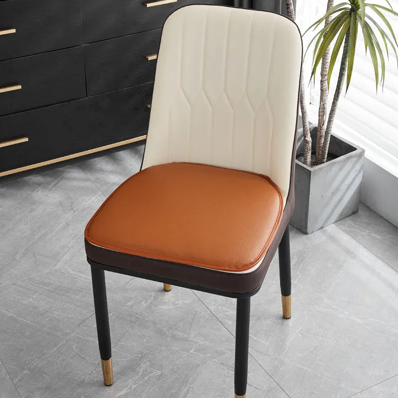 Leather horseshoe-shaped seat cushion in beige colour showing thickness and shape