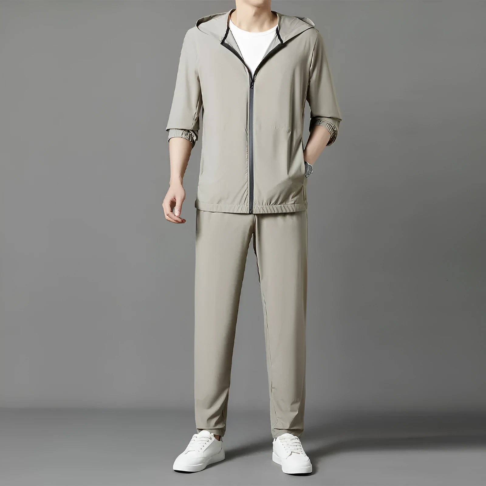 Grey loose-fit hooded sun-protective jacket and trousers set on a hanger