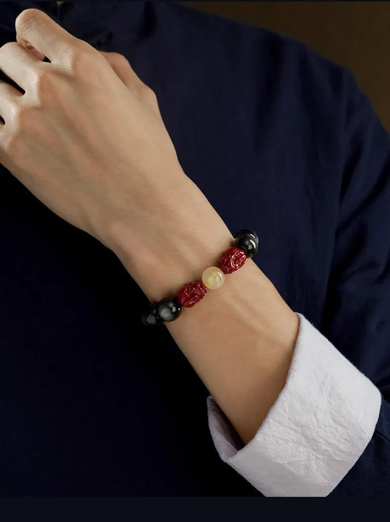 Hand-carved cinnabar bead bracelet with Jinniu zodiac design in gold obsidian colour