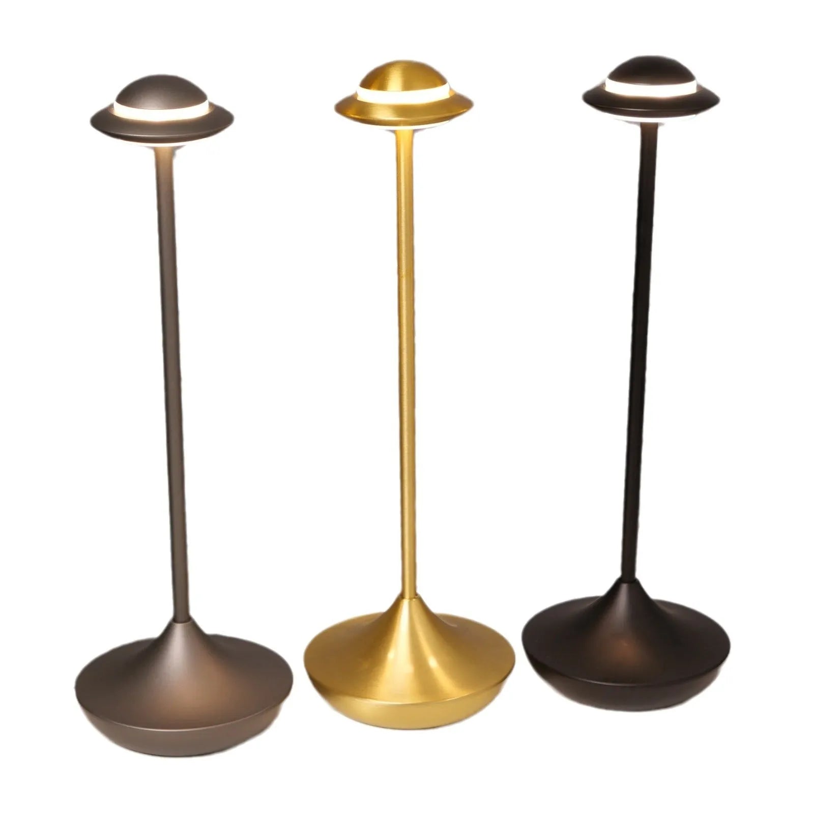 Modern metallic UFO-shaped table lamp with touch base in black, on a wooden desk.