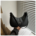 Women's black dumpling-shaped PU shoulder baguette handbag with a single strap and sewing thread detail.