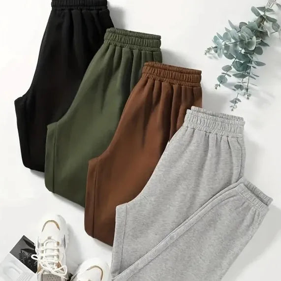 Four women's polyester sweatpants in black, green, brown and grey with straight leg and mid waist design