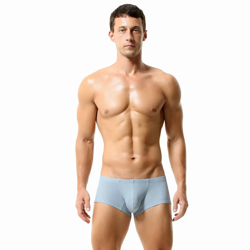 Solid colour low waist men's boxers in nylon fabric on a white background