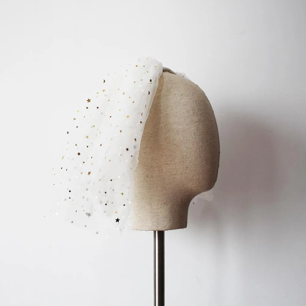White yarn bridal multi-layer short veil with hair comb on a neutral background