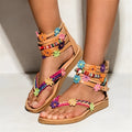 Ethnic beaded petal sandals with floral decoration and round toe.