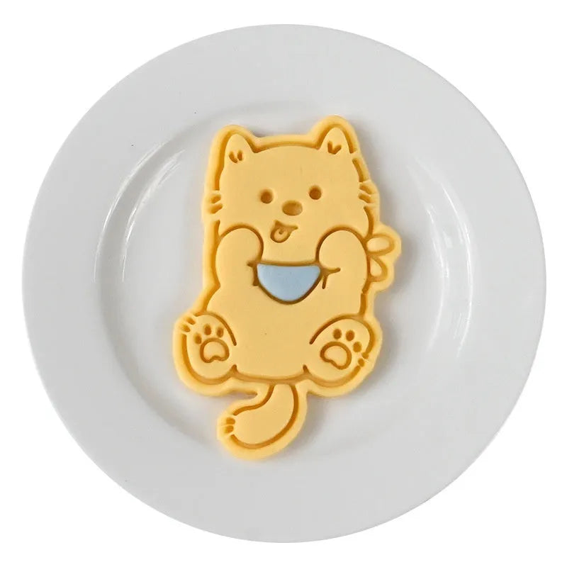 Three-dimensional plastic biscuit mould set with puppy cartoon designs including birthday hats and swimming rings