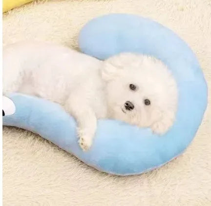 Blue and yellow question mark shaped cat bed with a U-shaped pillow for neck support on a wooden floor.
