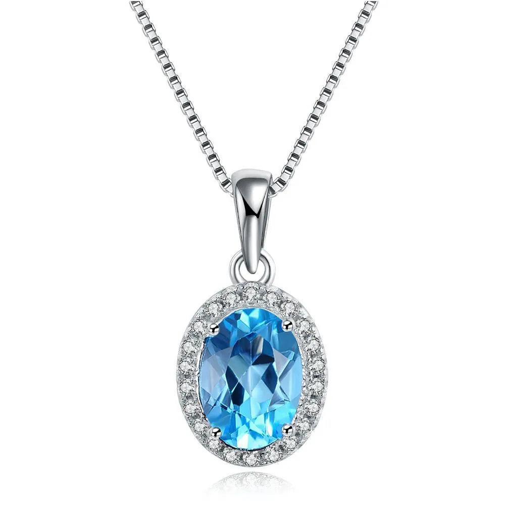 925 sterling silver blue topaz geometric jewellery set showing necklace, earrings, ring, and pendant