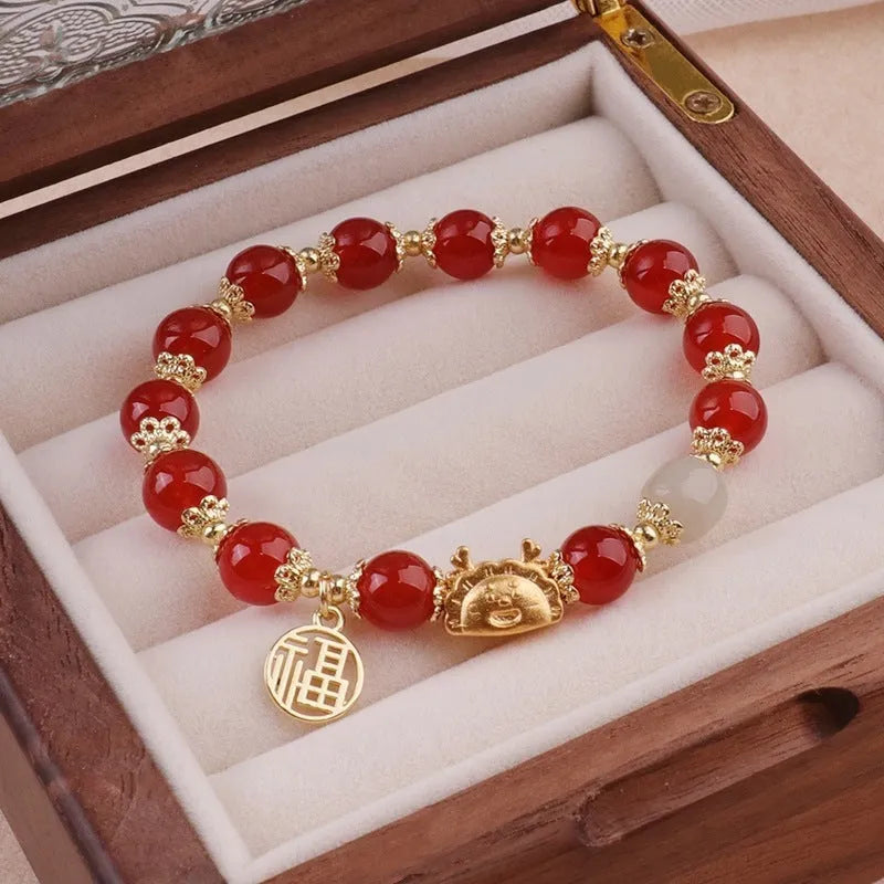Women's floral glazed bracelet with animal zodiac motifs on coloured glass beads in red, pink, and white variants