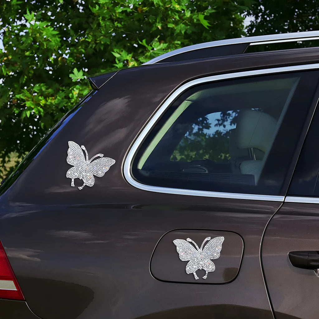 Close-up of a white diamond glass car sticker with a butterfly and bear paw design.