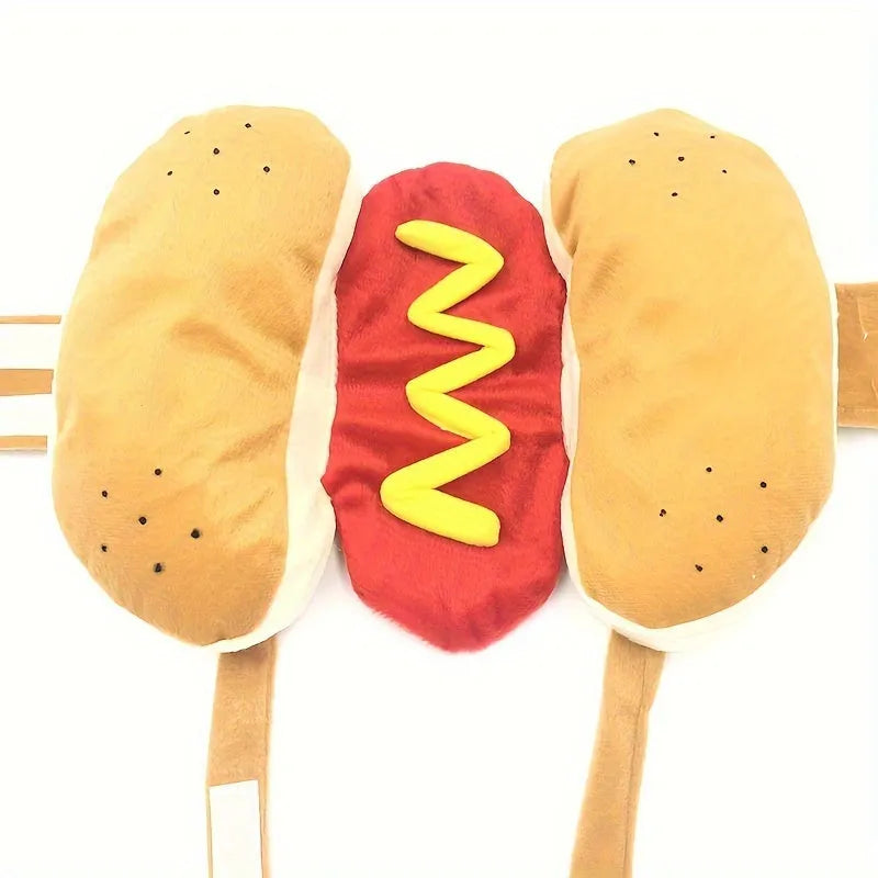 A small dog wearing a red and brown plush hot dog costume with a hood and leg openings.