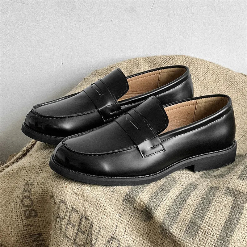 Black men's classic slip-on derby leather shoes with a rubber sole on a white background