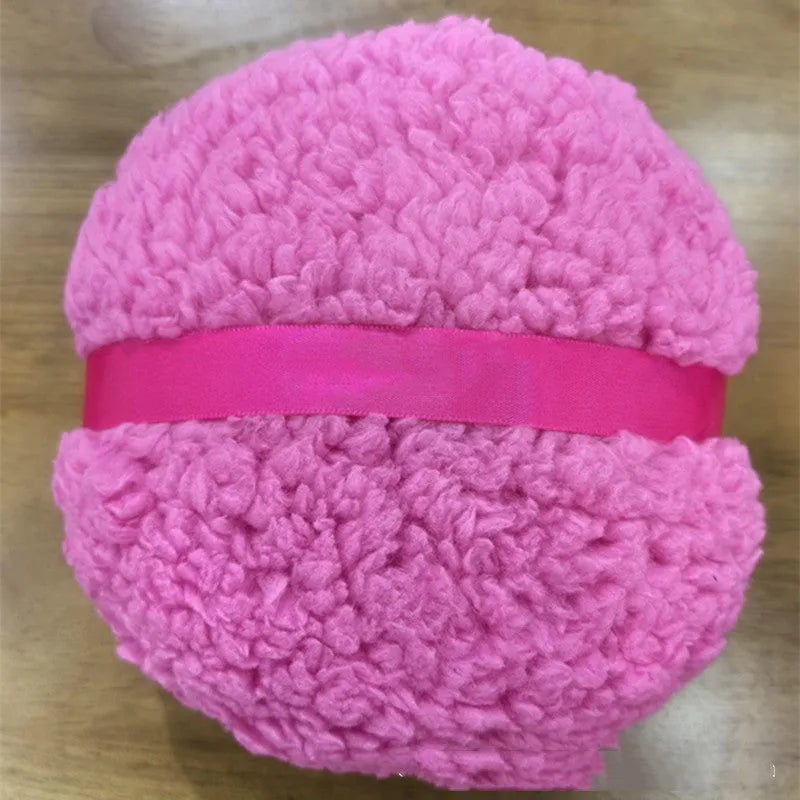 Large rectangular plush powder puff for makeup application in pink, white, or skin colour.