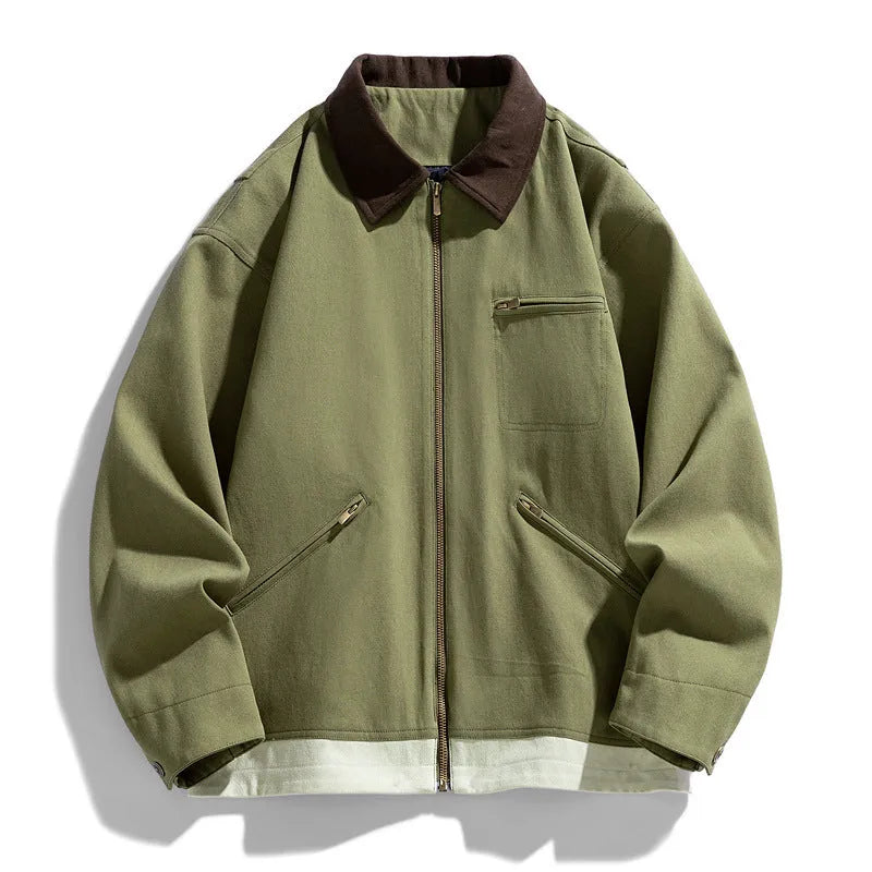 Man wearing a mint green retro-style loose fit jacket with dark contrasting lapels and side seam pockets.