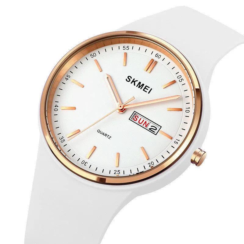 A women's silicone strap quartz watch with calendar on a white dial, showing a stainless steel pin buckle.