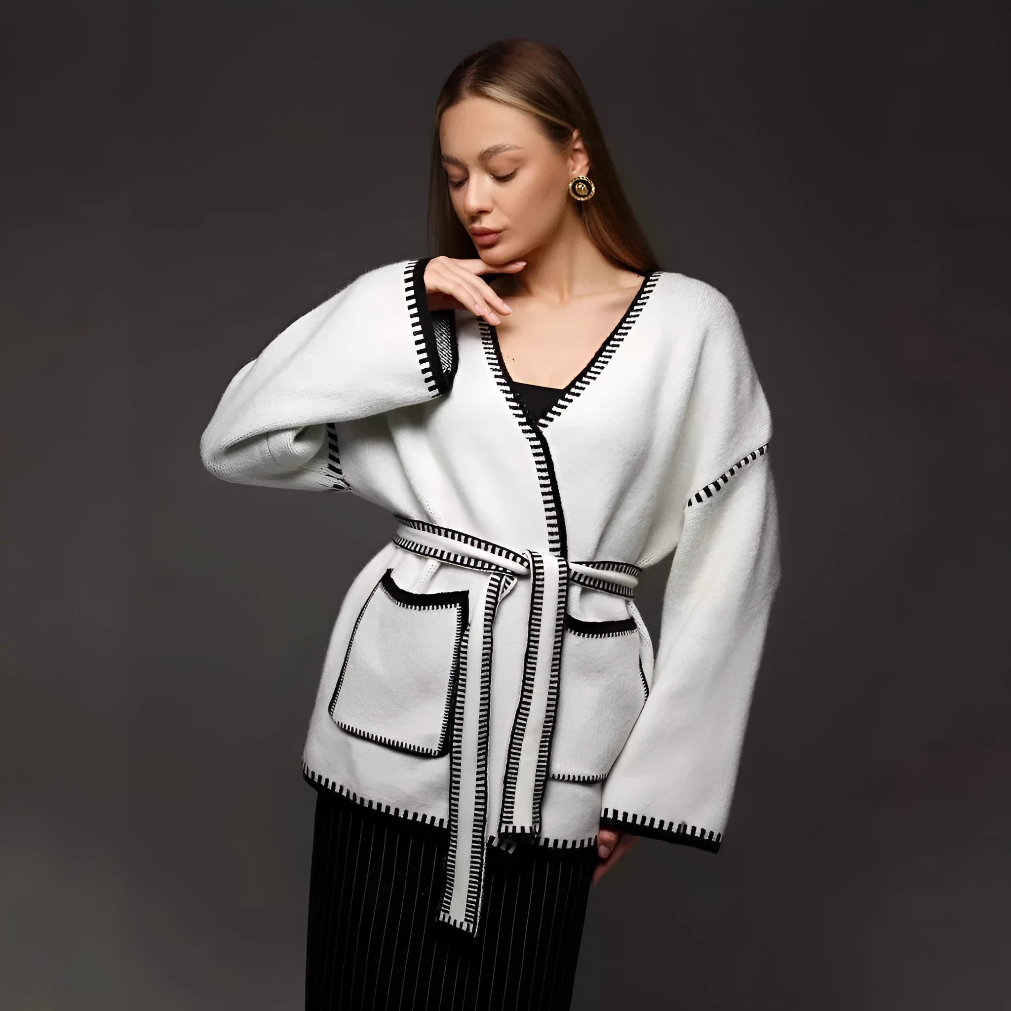 Lace-up front knitted cardigan in black, camel, or white, showing loose fit and thick fabric.