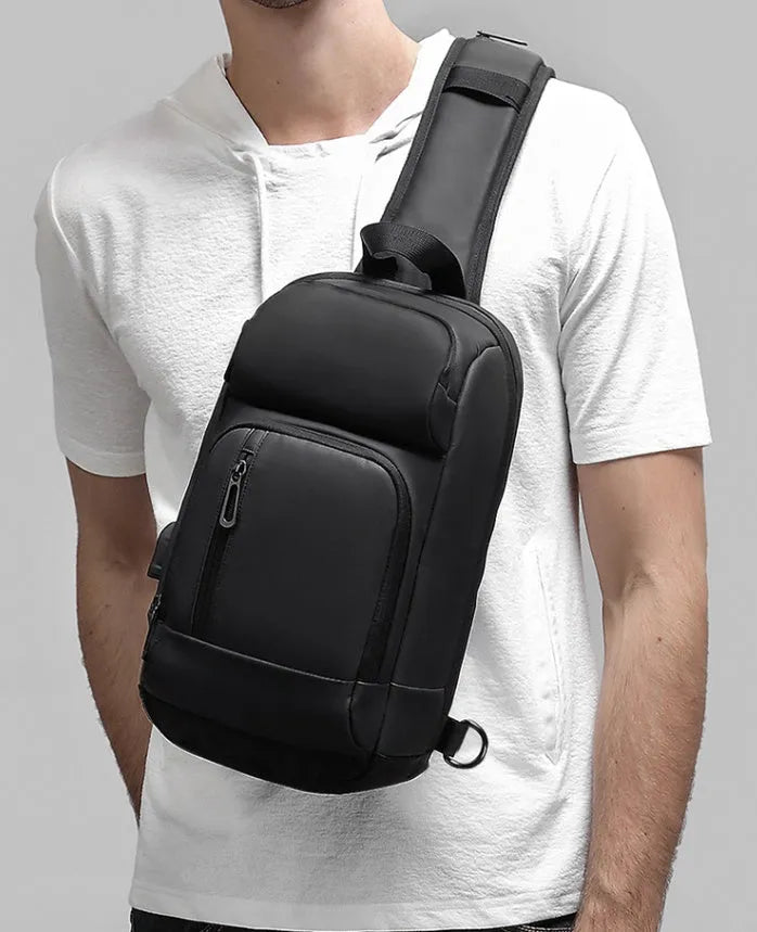 Black medium-sized PVC shoulder bag showing front zipper, air cushion strap, and internal laptop pocket.