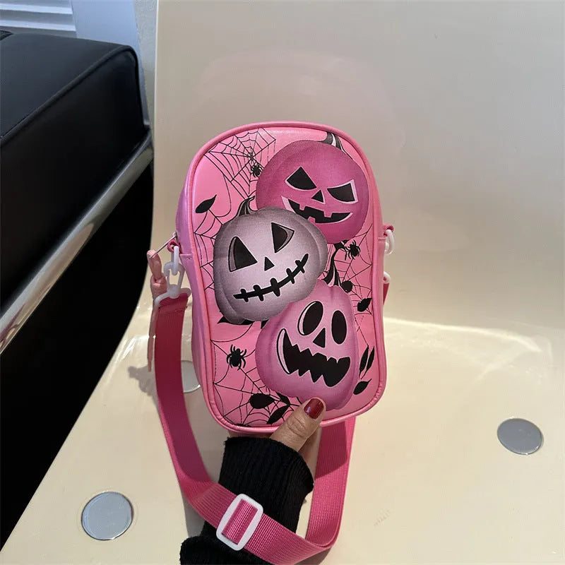 Black mini square crossbody bag with orange Halloween graffiti print of cartoon pumpkin, ghost, and bat.
