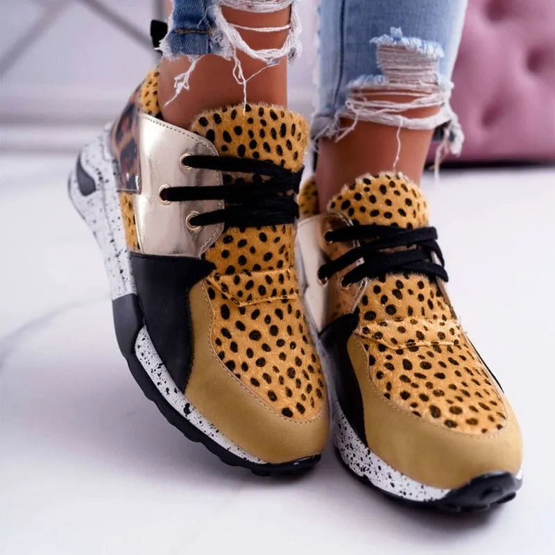 Women's casual suede wedge sneakers in leopard print with a low-cut design and plastic sole.