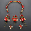 Costume jewellery set with bride headdress and hair ornaments featuring rhinestone and pearl details on gold metal