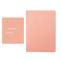Blue and pink soft touch A5 dotted notebooks showing dot grid pages and imitation leather cover.