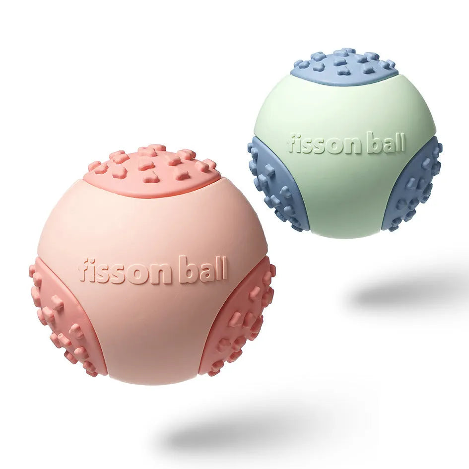 Green and pink durable rolling ball dog toy with a 64mm diameter on a plain background.