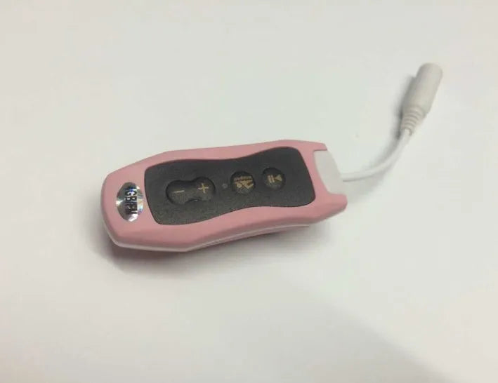 Compact black waterproof MP3 player earphone with USB cable, shown next to a ruler for scale.