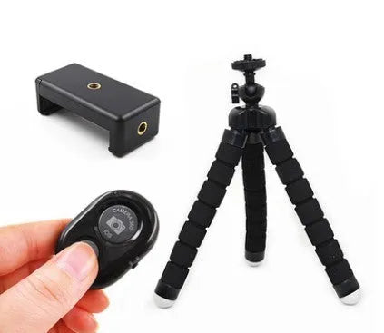 Black flexible octopus tripod with bent legs wrapped around a pole, showing a smartphone attached.