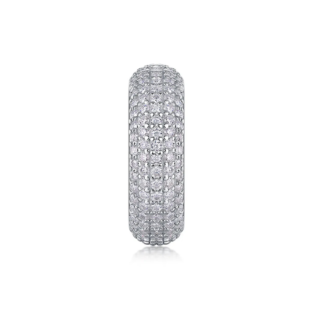Moissanite wedding ring with S925 silver platinum plated band on flat surface showing stone and certificate