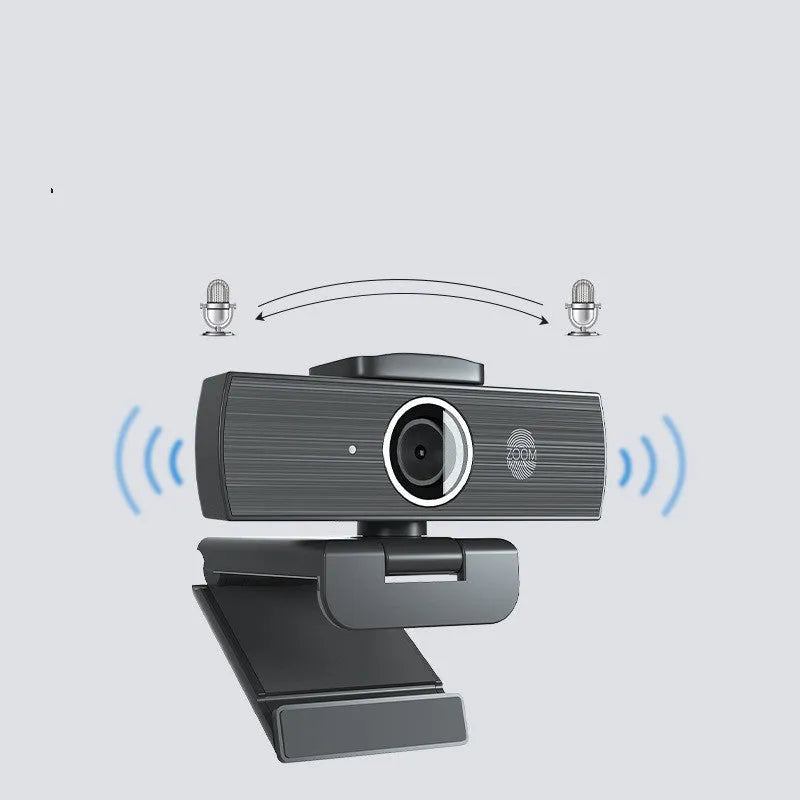 Black 4K USB webcam with auto focus on a desktop, shown with its magnetic privacy cover.