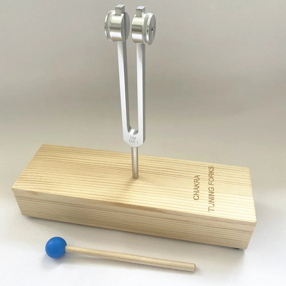 Aluminium alloy 432Hz tuning fork and portable speaker kit on a kraft paper box.