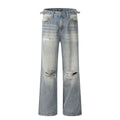 Man wearing blue ripped straight-leg jeans in a retro style with a zip fly.