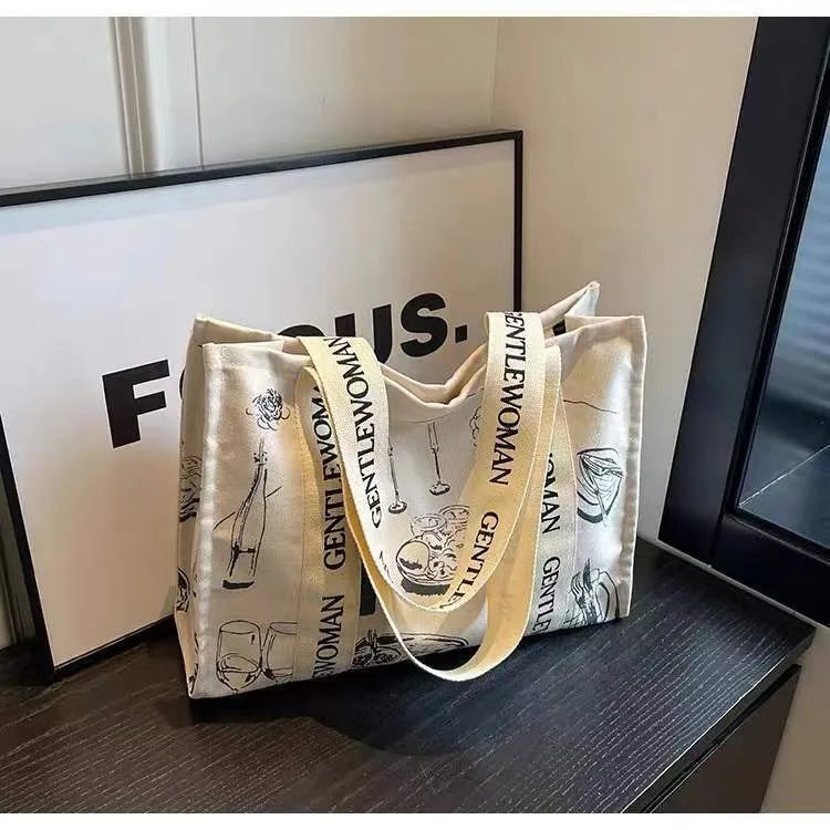 Large canvas women's tote bag with printed design, shown in available colour options.