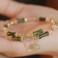 Women's bamboo beaded bracelet with coloured glaze beads and bamboo joints in plum wine colour